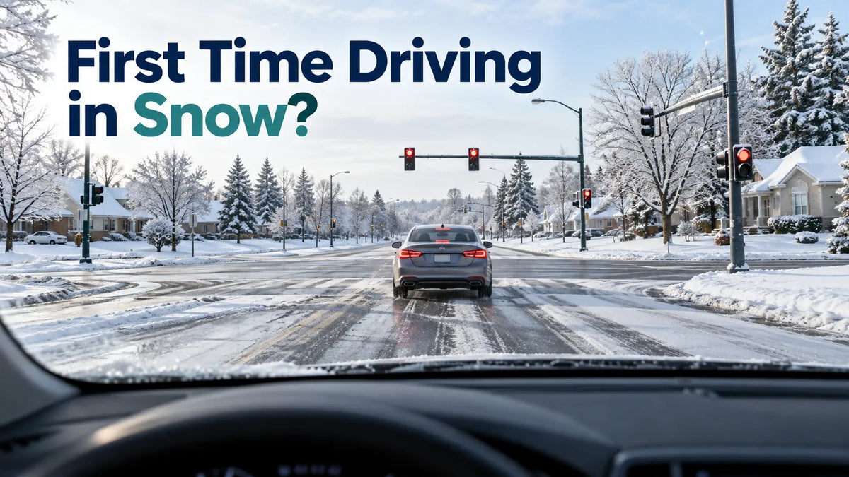A car driving cautiously along a snow-covered suburban road during winter.
